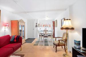 a living room with a red couch and a table at FY406-Faaborg-Bojestraede-4-A in Faaborg