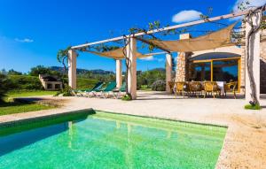 a pool in a backyard with a gazebo at Can Carrio in Son Servera