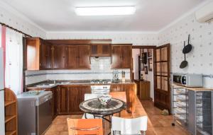a kitchen with wooden cabinets and a table at Ca Na Siona in Alcudia +39 photos