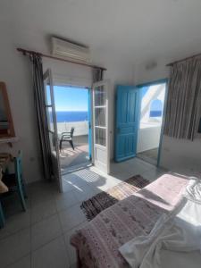 a bedroom with a bed and a view of the ocean at Sunset Studio Apartments in Kalymnos