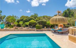 a swimming pool in a yard with a umbrella at Es Socorrat in Portocolom