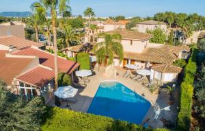 an aerial view of a house with a swimming pool at Casa Romantica De Sa Coma in Sa Coma