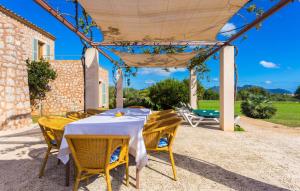 a table and chairs under a pergola on a patio at Can Carrio in Son Servera +44 photos