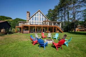 a group of chairs sitting in front of a house at Arcadia by Railey Vacations in McHenry +59 photos