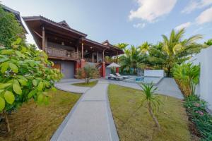 an image of a villa with a garden and a walkway at Calisto Valley I Luxury Pool Villa Krabi in Ao Nam Mao