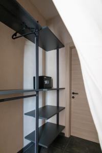 a room with black shelves and a door at Sonrisa Suites in Taranto +29 photos