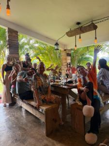 a group of people sitting at a table in a restaurant at Eco Lodges Chalets Tropicales Playa Macao in Punta Cana