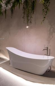 a white bath tub on display in a bathroom at Sonrisa Suites in Taranto