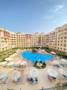 an aerial view of a pool with umbrellas and chairs at Florenza Khamsin Resort in Hurghada