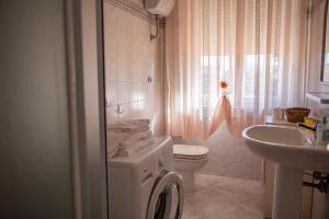 a bathroom with a washing machine and a sink at Cav Costa degli Etruschi in San Vincenzo +43 photos