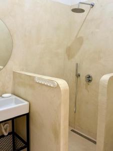 a bathroom with a shower and a sink at SĀN Living in Golem +35 photos