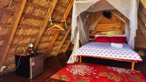 a bedroom with a bed in a thatched room at Eco Lodges Chalets Tropicales Playa Macao in Punta Cana +89 photos