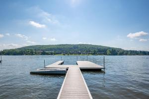 a dock in the middle of a lake at Arcadia by Railey Vacations in McHenry