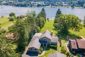 an aerial view of a house on a hill next to the water at Arcadia by Railey Vacations in McHenry