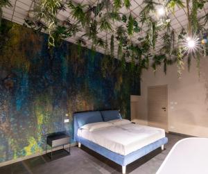 a bedroom with a bed and a colorful wall at Sonrisa Suites in Taranto