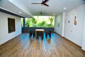 a dining room with a table and chairs at Wayne Nest Calangute in Calangute