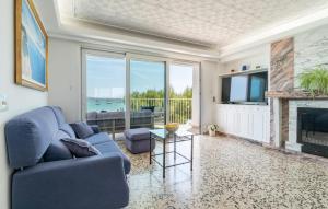 a living room with a blue couch and a fireplace at Voramar On Pinewalk in Pollença
