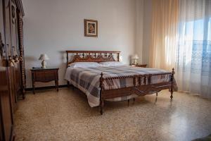 a bedroom with a bed and a dresser and a window at Cav Costa degli Etruschi in San Vincenzo