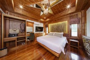 a bedroom with a bed and a desk in it at Calisto Valley I Luxury Pool Villa Krabi in Ao Nam Mao +57 photos