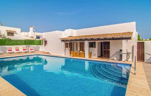 a swimming pool in front of a villa at Murta 26 in Sa Coma