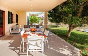 a dining table and chairs on a patio at Sa Mina De Crestatx in Sa Pobla +39 photos