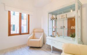 a living room with a chair and a glass cabinet at Convent in Alcudia