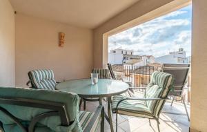 a patio with a table and chairs and a window at Atico Roger De Flor in Port de Pollensa