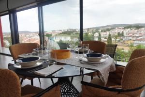 a dining table with a view of a city at Casa do Pessegueiro in Mirandela