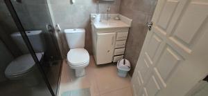 a small bathroom with a toilet and a sink at Base Luz na Floresta in Manaus