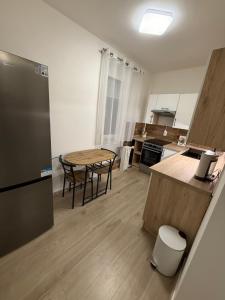 a kitchen with a wooden table and a table and chairs at Tildy Apartman Pécs in Pécs +18 photos