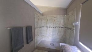 a bathroom with a shower with a shower curtain at The Spot at Ghanzi in Khemsbok +26 photos