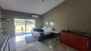 a bedroom with a bed and a view of a dog at The Spot at Ghanzi in Khemsbok