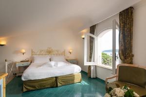 a bedroom with a large bed and a window at Grand Hotel Il Moresco in Ischia Town +58 photos