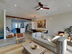 a living room with a couch and a ceiling fan at Gulf Place Spires #7B - Rum Cake in Santa Rosa Beach