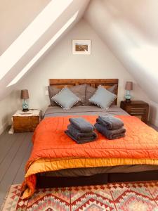 a bedroom with a bed with two pillows on it at La Grange de Timon in Laguiole