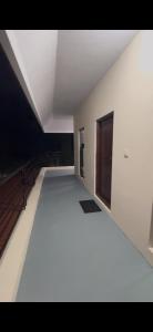 an empty room with a white floor and a window at Offline Resort in Bengaluru, Karnataka +1 photo