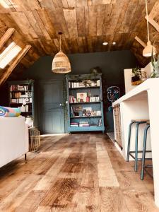a living room with a wooden ceiling at La Grange de Timon in Laguiole