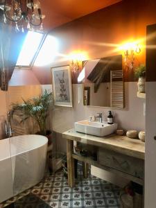 a bathroom with a tub and a sink and a bath tub at La Grange de Timon in Laguiole +38 photos