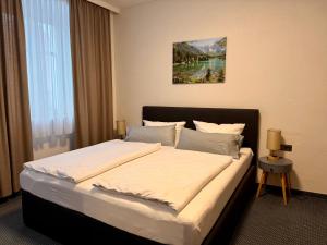 a bedroom with a large bed in a room at Gasthof Hotel Bräustübl und Haus Boutique in Selb