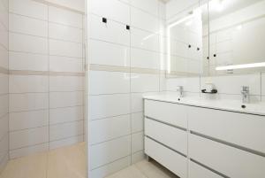a white bathroom with a sink and a mirror at Évasion à Bruguières in Bruguières +50 photos