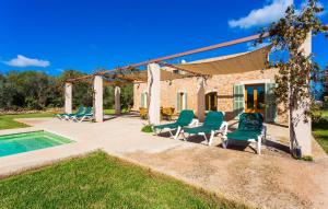 a patio with chairs and a swimming pool at Ses Fonolleres in Son Servera +44 photos