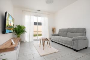 a living room with a couch and a table at Évasion à Bruguières in Bruguières