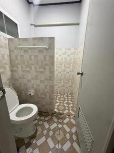 a bathroom with a toilet and a shower stall at Solara เฮ้าส์ in Ban Nong Saeng (4)