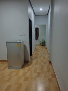 a hallway with a wooden floor and a refrigerator at Solara เฮ้าส์ in Ban Nong Saeng (4) +1 photo