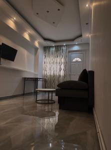 a living room with a couch and a table at Casa Luna Luxury Apartment in Nea Moudania