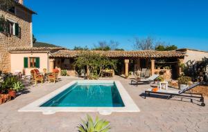 a backyard with a swimming pool and a house at Frontera in Sóller