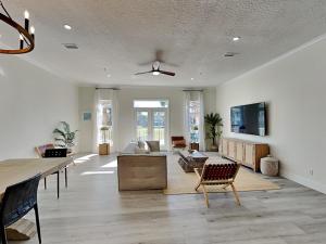 a large living room with a couch and a tv at Gulf Place Spires #7B - Rum Cake in Santa Rosa Beach