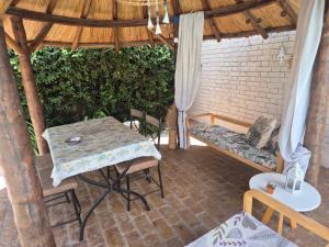 a patio with a table and chairs in a pavilion at Dharma in Ciudad Lujan de Cuyo