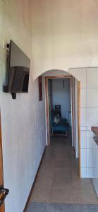 a hallway leading to a living room with a television at Cabañas Cerro Colonial in Trapiche