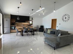 a living room with a couch and a table at Apartma Rozi Deluxe in Koper